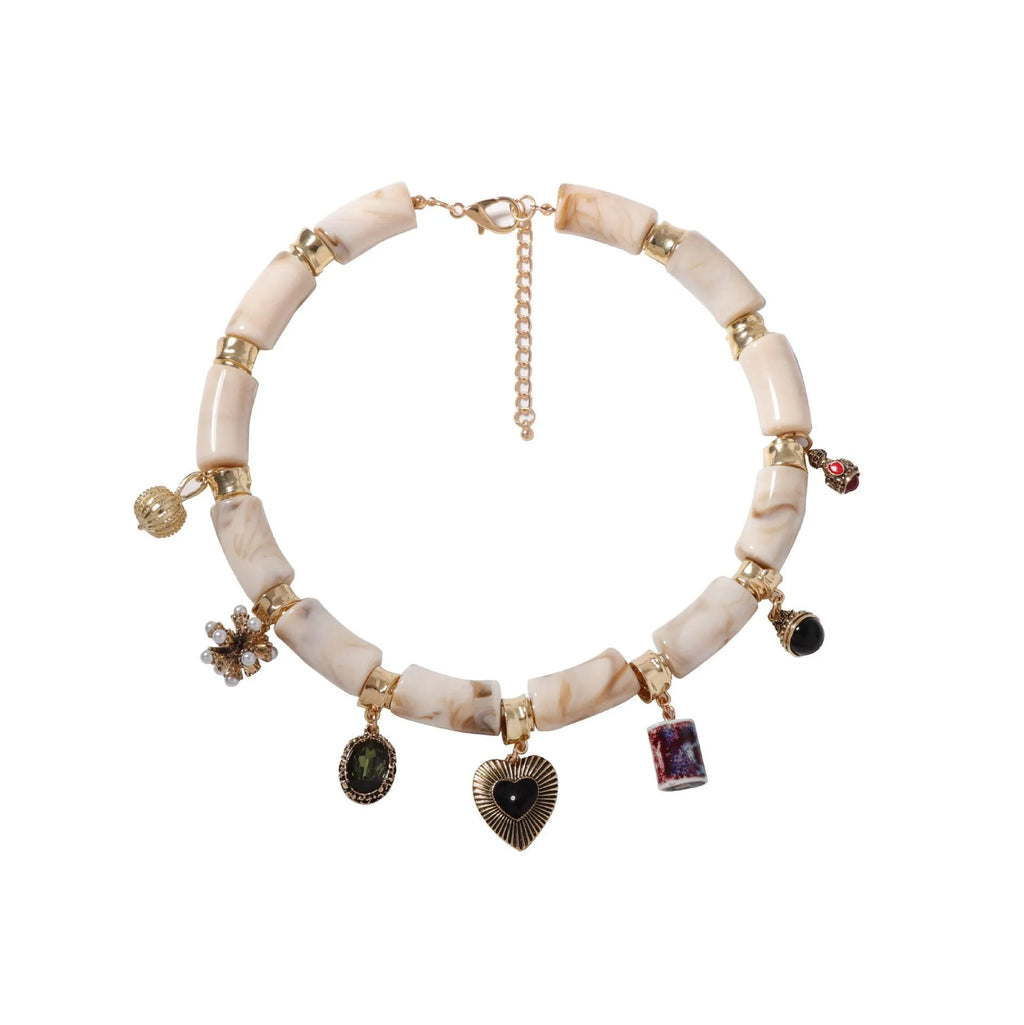 Bamboo-shaped resin pendant necklace with heart charm and electroplated finish.