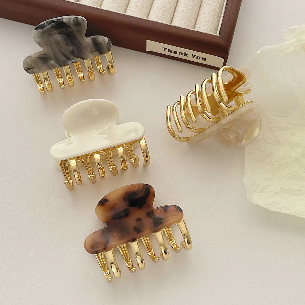 Medium metal grip women's barrette in retro acetate style, alloy acrylic construction, shown in one of four colour options.