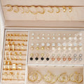 108 geometric earrings in gold and yellow electroplated finishes with round decorative elements