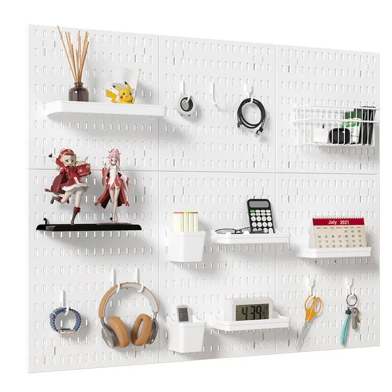 White punch-free plastic cable organisation board mounted on a wall with wires neatly wrapped.