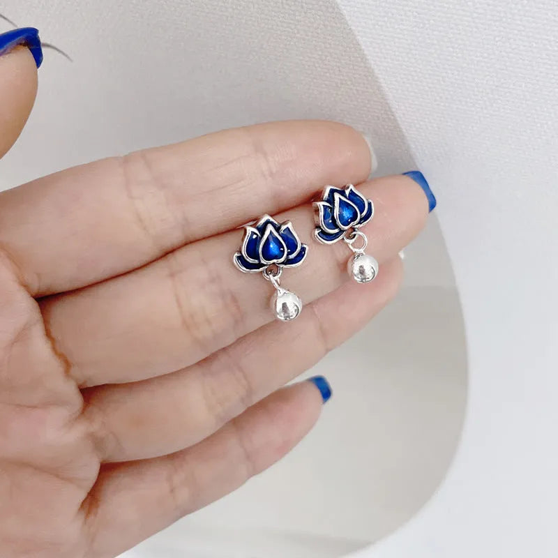 Blue lotus flower and seedpod tassel drop earrings with silver needle details on alloy studs.