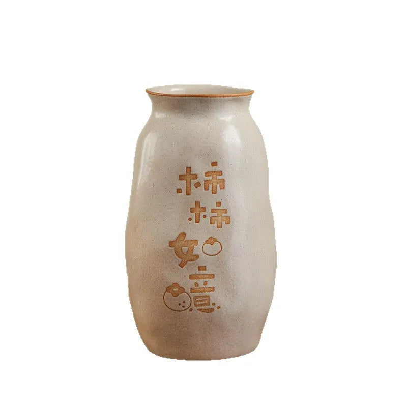 Chinese hand-painted ceramic vase with carved design on wooden desk