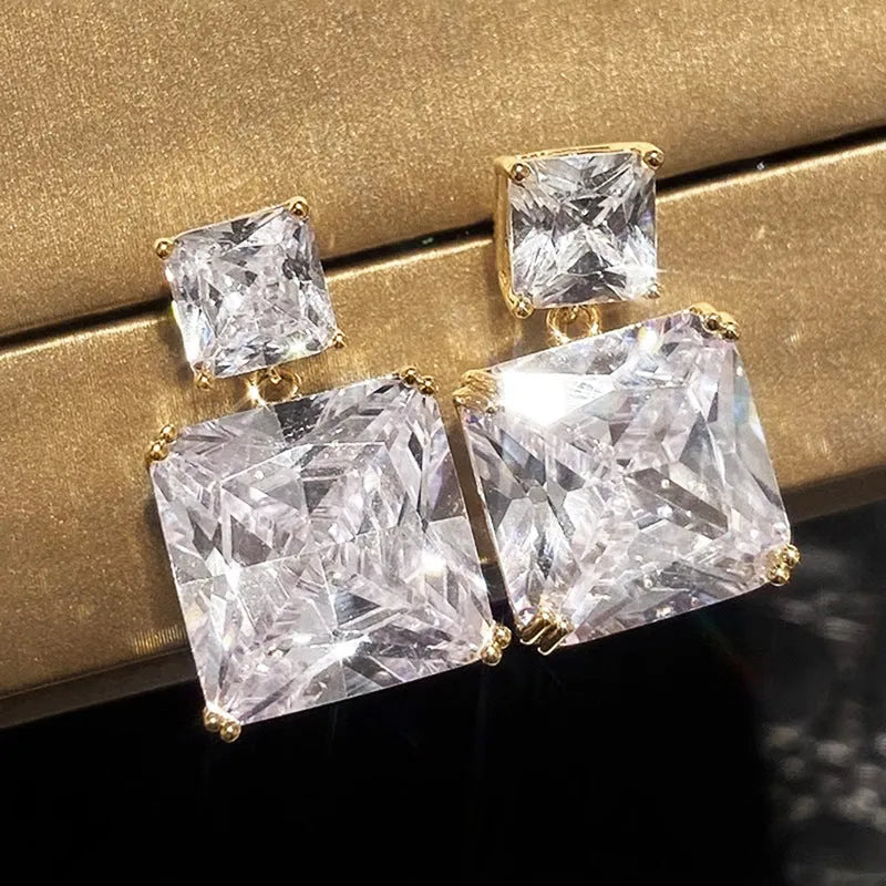 A pair of women's geometric square earrings in copper with a choice of white gold or gold colour finish.