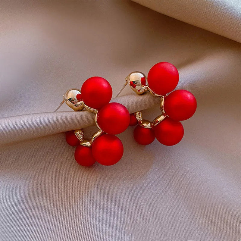 Red bell-shaped alloy earrings for women shown alongside white colour option