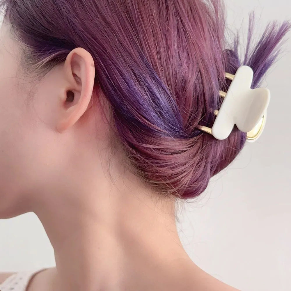 Medium metal grip women's barrette in retro acetate style, alloy acrylic construction, shown in one of four colour options.