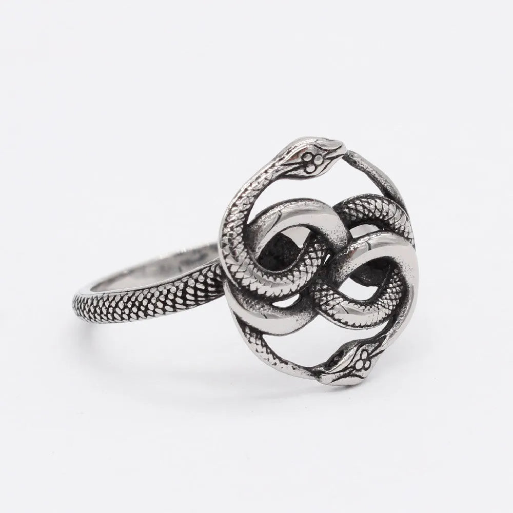 Close-up of a titanium steel double snake ring with a retro design on a hand, showing the intricate intertwined serpent detail.
