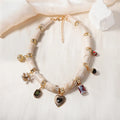 Bamboo-shaped resin pendant necklace with heart charm and electroplated finish.