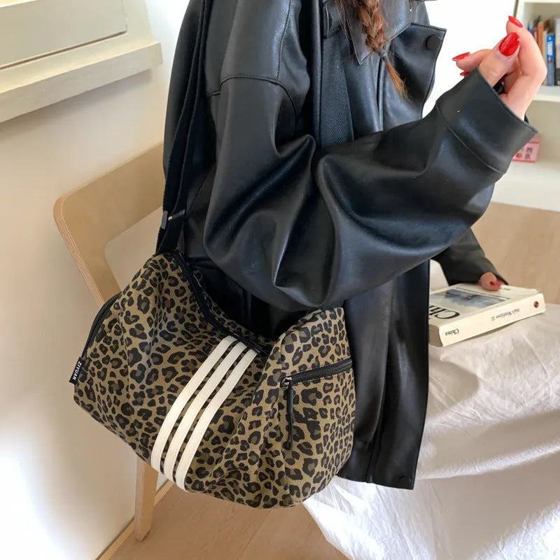 Leopard print sports style shoulder messenger bag with crossbody strap and striped lining