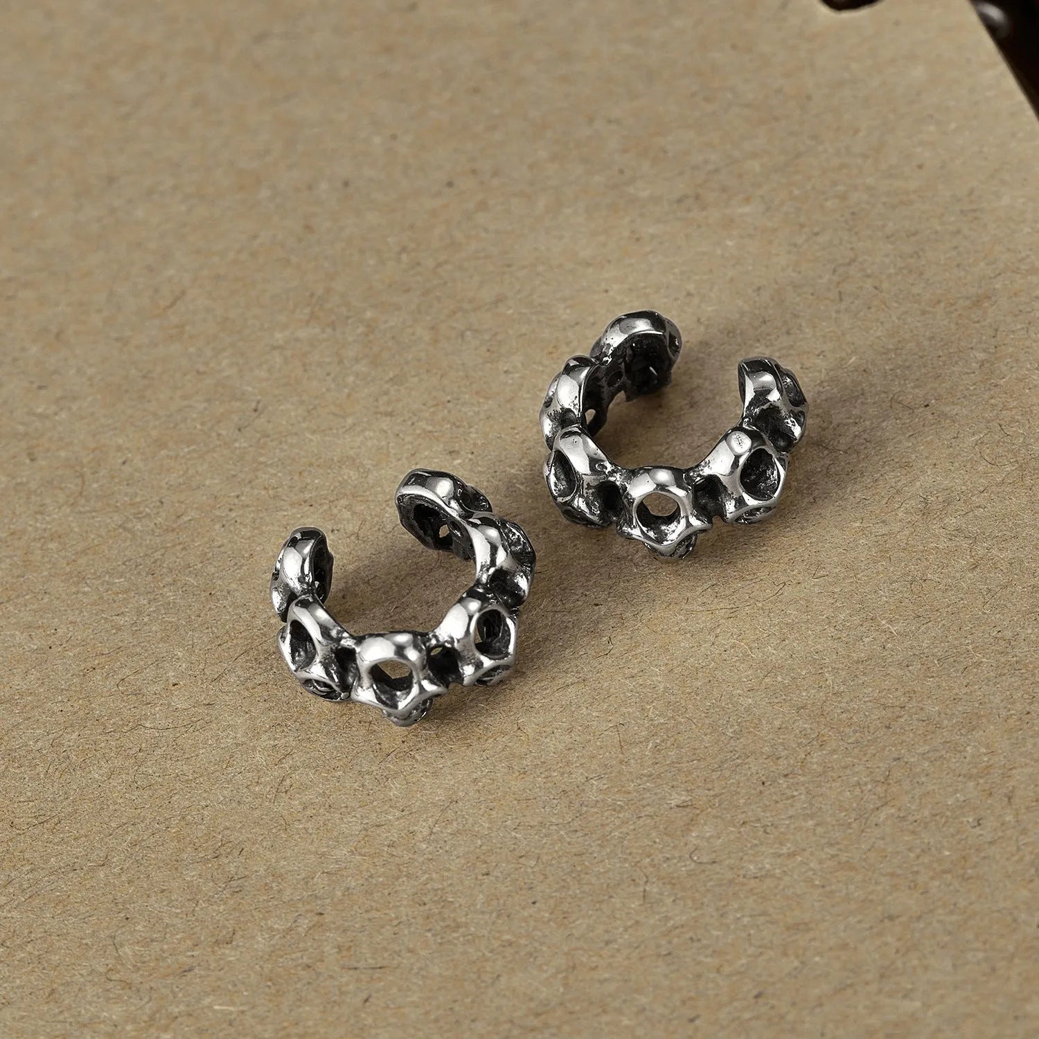 Stainless steel skull ear clip earrings with geometric hollow design and electroplated finish