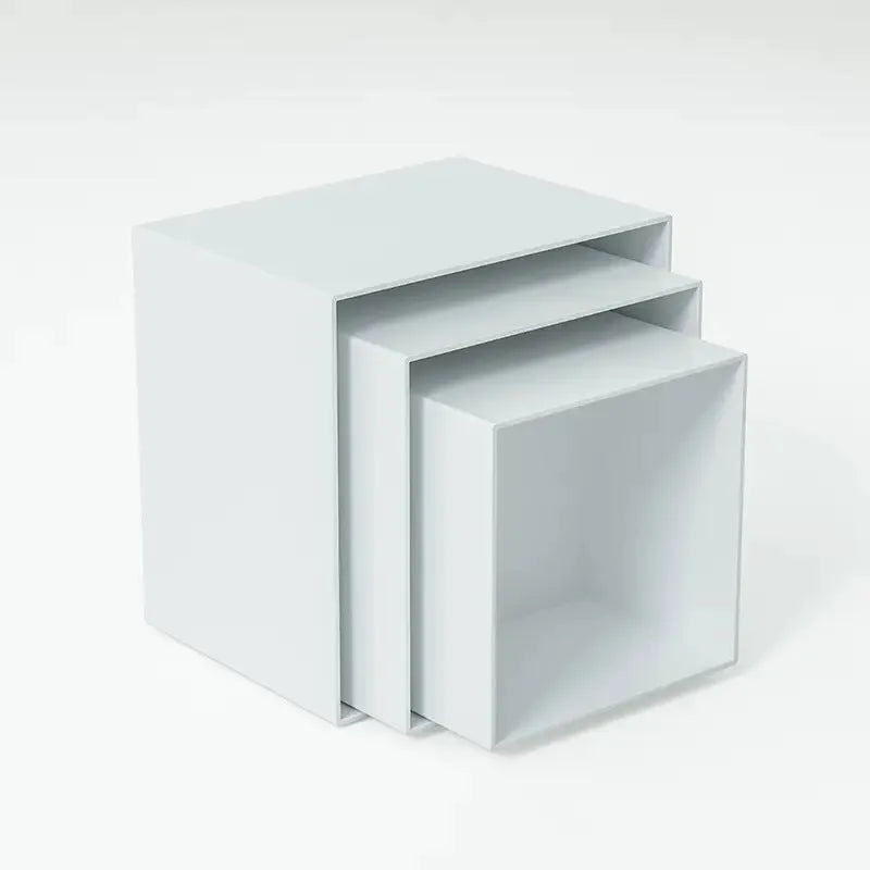 White plastic modular dessert display stand cubes stacked to form a tiered tabletop cake stand.