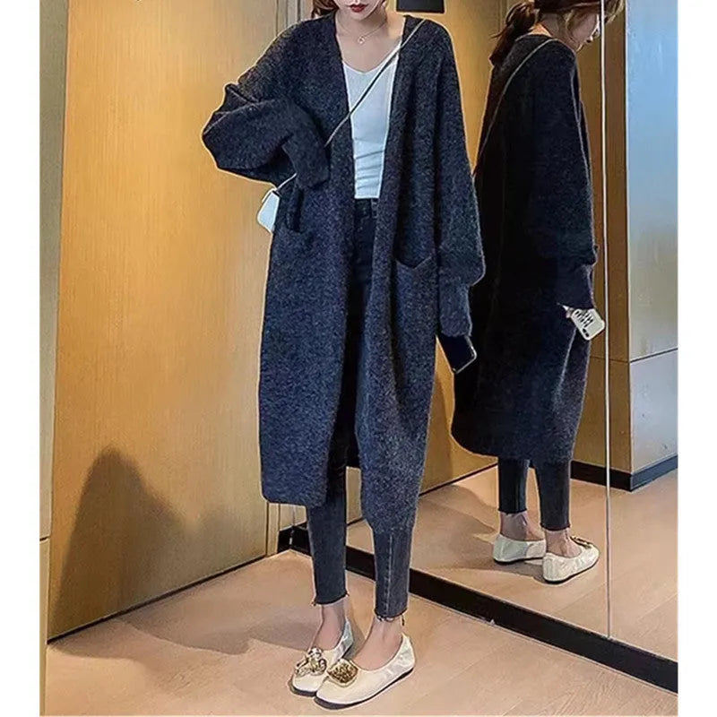 Women loose mid-length knitted cardigan in solid colour with long sleeves and pockets.