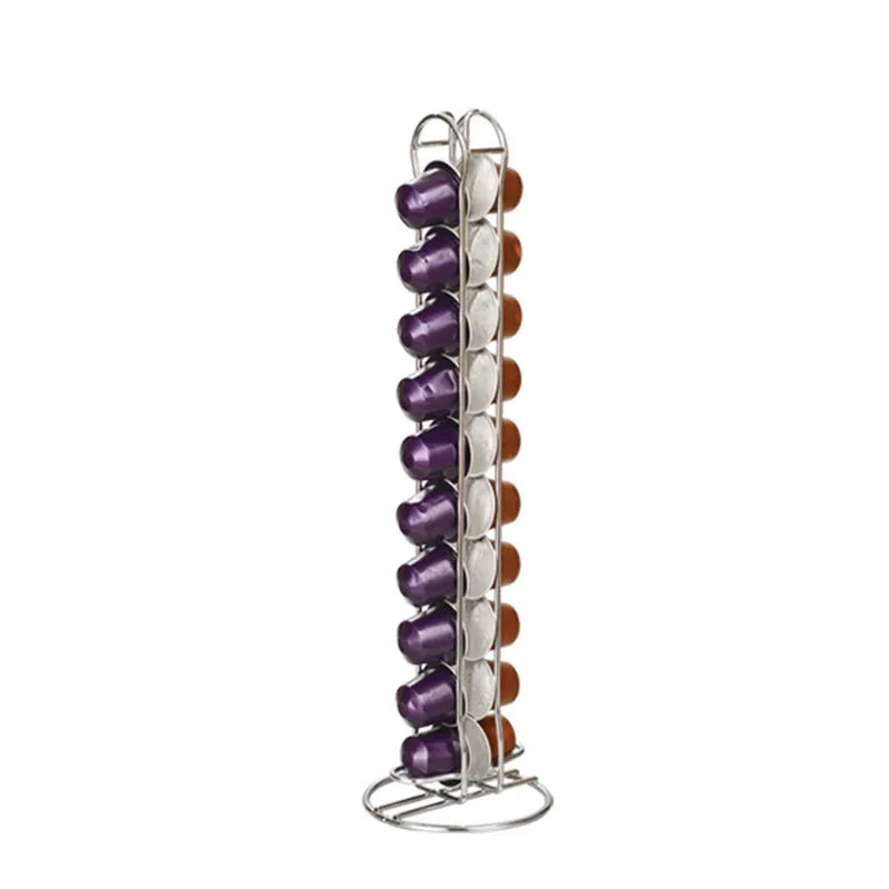Black and silver wrought iron coffee capsule storage rack holding pods on shelves.