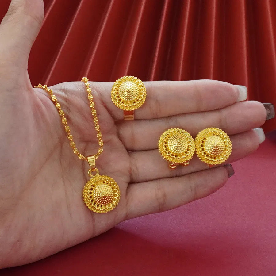 Gold-plated three-piece jewellery set with landscape flower design showing necklace, earrings and ring