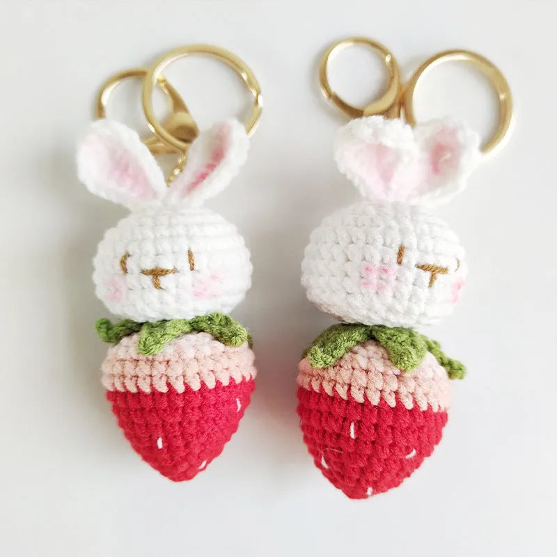Hand-woven white rabbit strawberry cartoon charm pendant with a key attached