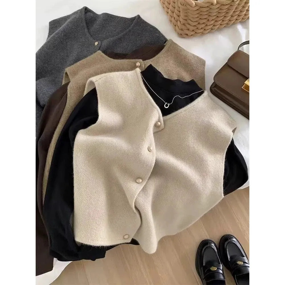 Thin polyester pullover vest with half sleeves in various colours on a hanger