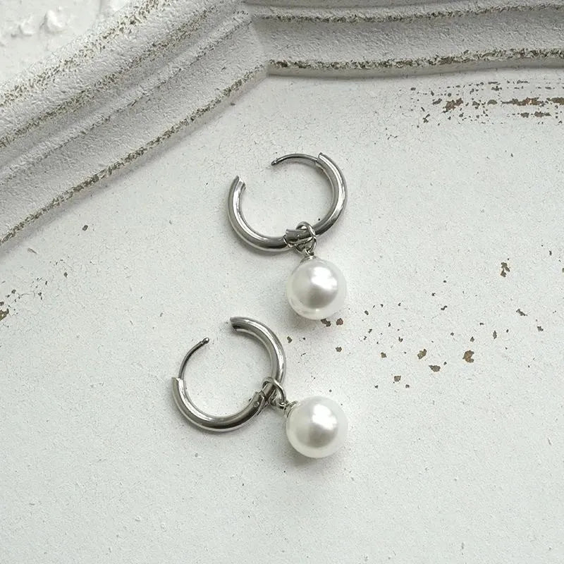 Geometric women's pearl drop earrings with alloy frame and titanium steel fittings.