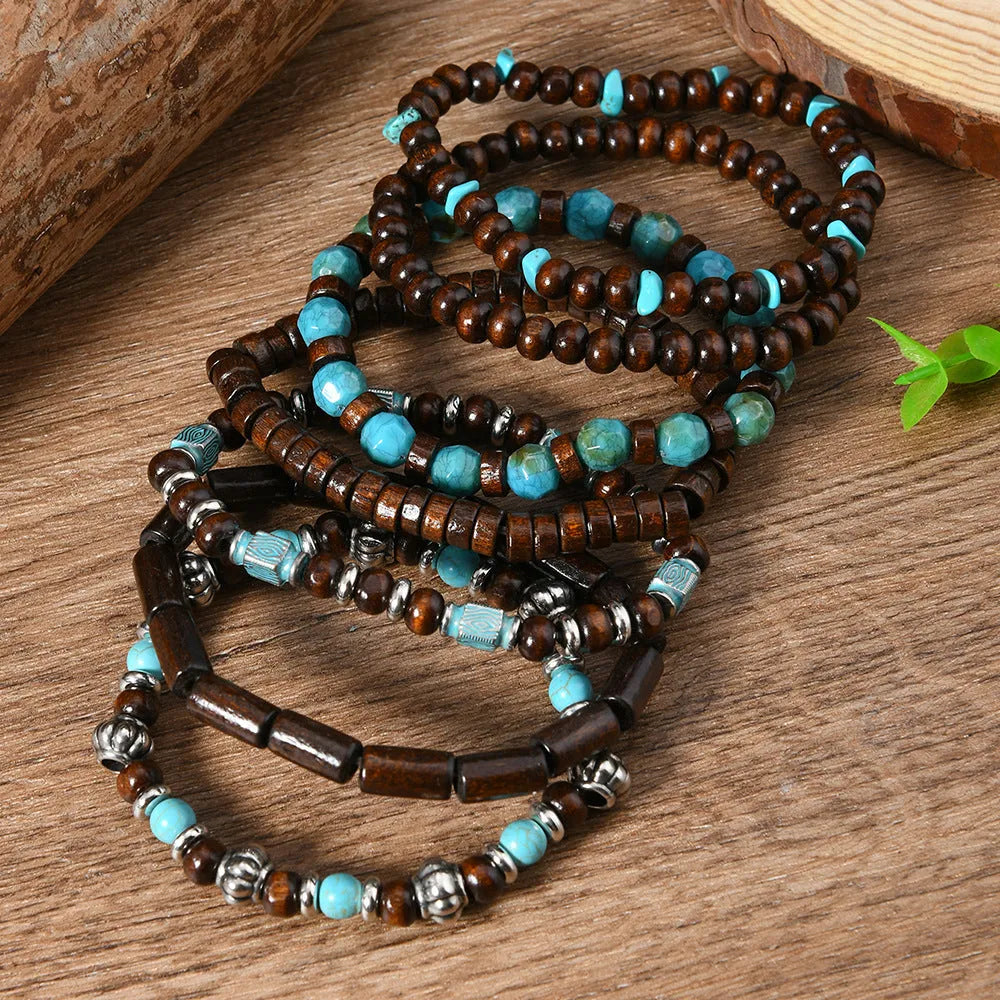 Set of seven multicolour retro bracelets with wooden beads and alloy accents laid flat.