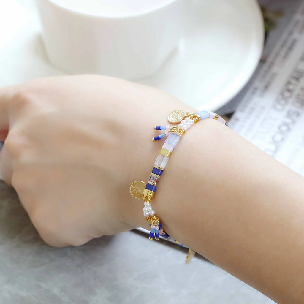 Women's handmade bracelet with glass coloured imitation pearl beads on wrist, showing one of six available colour styles.