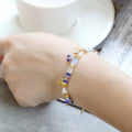 Women's handmade bracelet with glass coloured imitation pearl beads on wrist, showing one of six available colour styles.