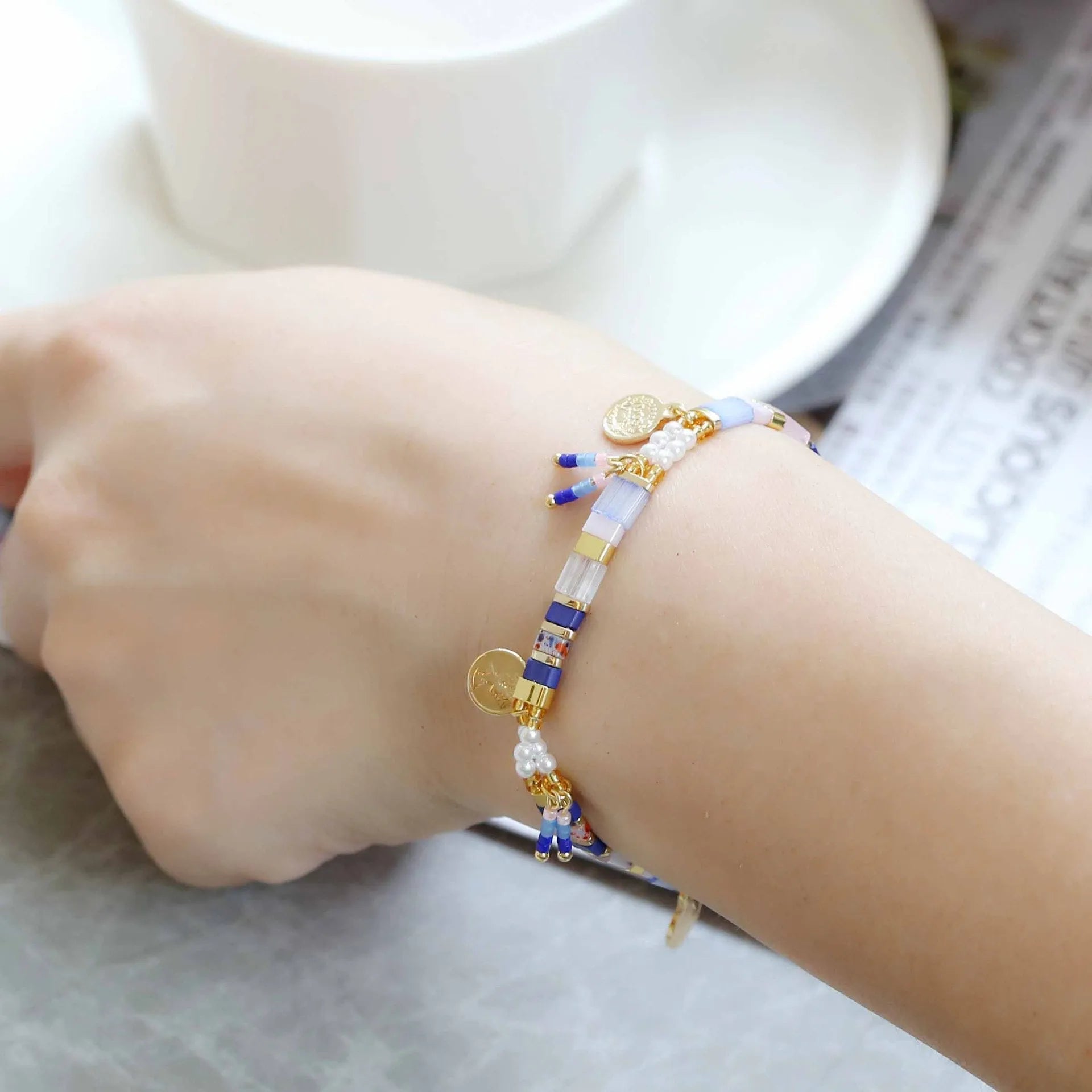 Women's handmade bracelet with glass coloured imitation pearl beads on wrist, showing one of six available colour styles.