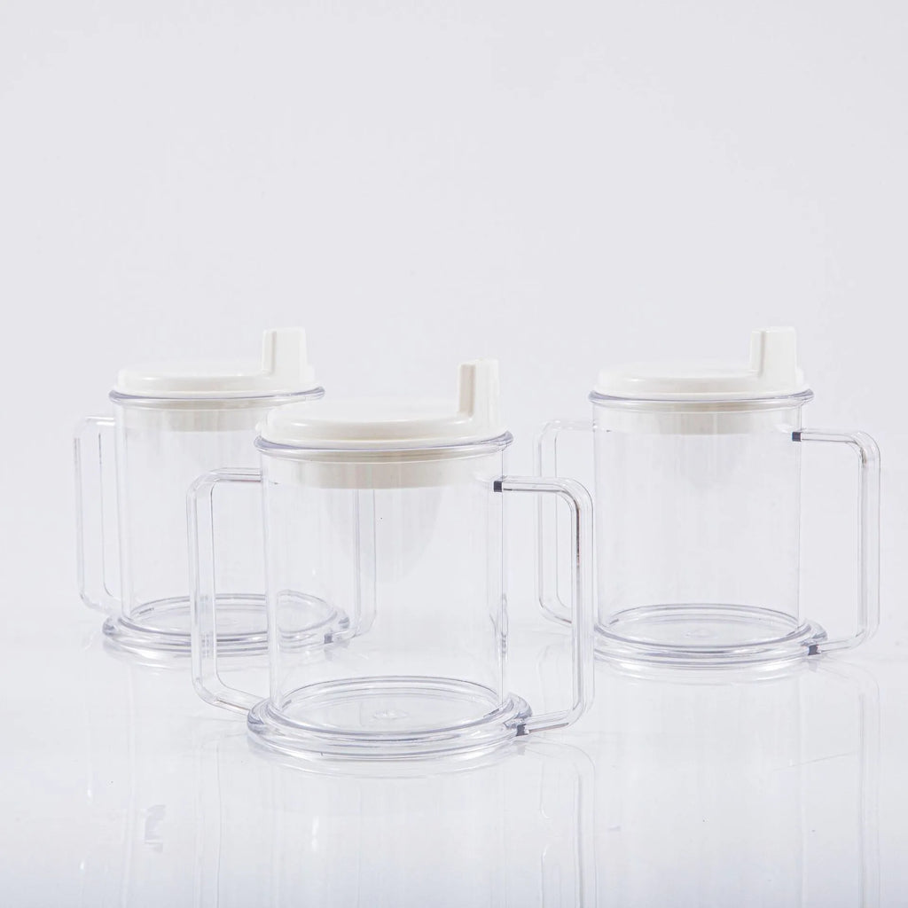 Transparent plastic drinking cup with spill-proof design on a plain background.
