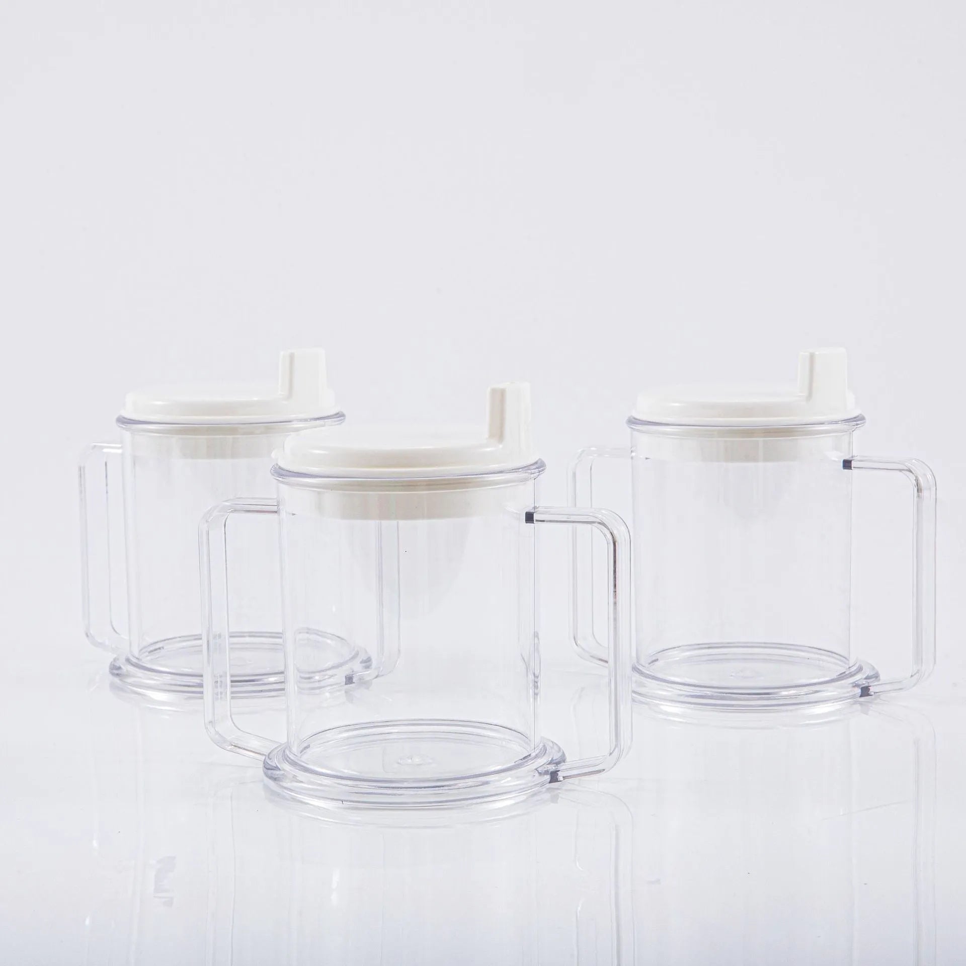 Transparent plastic drinking cup with spill-proof design on a plain background.