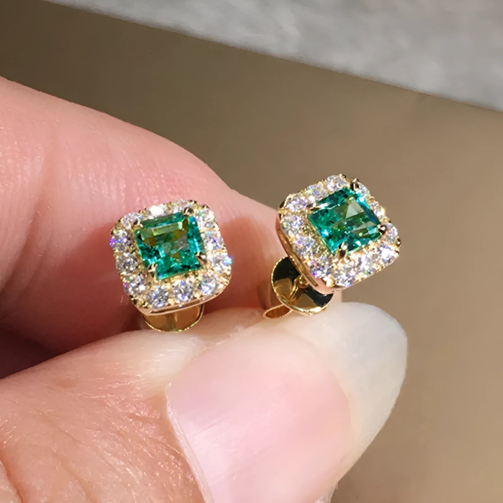 Square-cut grandmother green zircon stud earrings in electroplated copper with gold or white gold colour options.