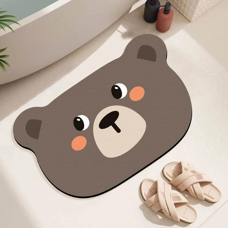 Cute cartoon animal diatomaceous earth bath mat in alien shape on bathroom floor.