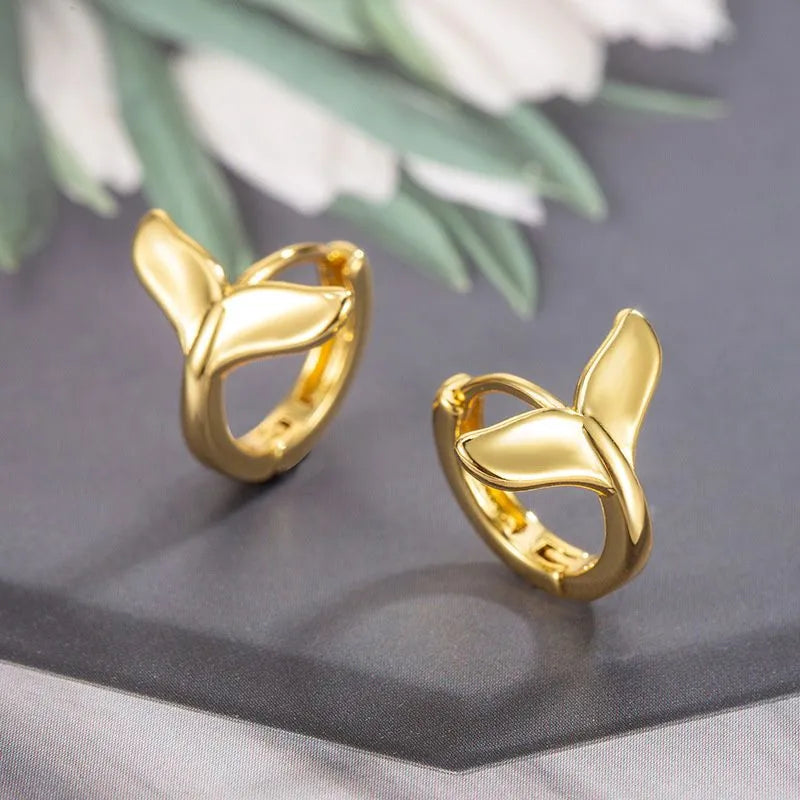A pair of simple women's fishtail earrings with an electroplated metallic finish.