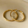 A pair of gold-coloured metal circle hoop earrings on a 40mm diameter.