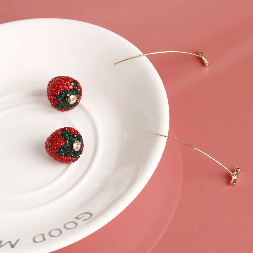 Geometric red strawberry stud earrings with spot-drill texture on a zinc alloy charm.