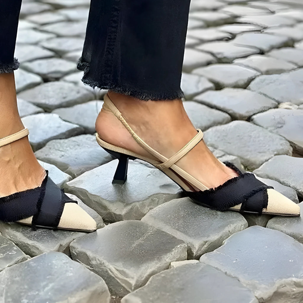 Women's apricot and black colour block stiletto heel sandals with pointed toe and buckle strap.