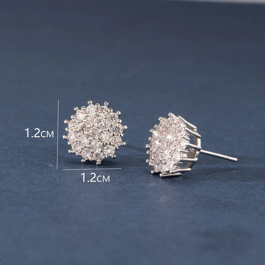 Pair of copper electroplated stud earrings in silver with irregular and round shapes on white background
