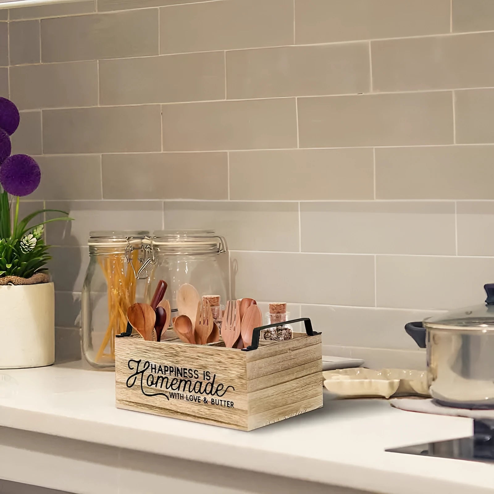 Wooden kitchen storage box with internal grid dividers for organising utensils.