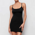 A black sleeveless sling dress with a slim sheath silhouette and short hemline on a hanger.