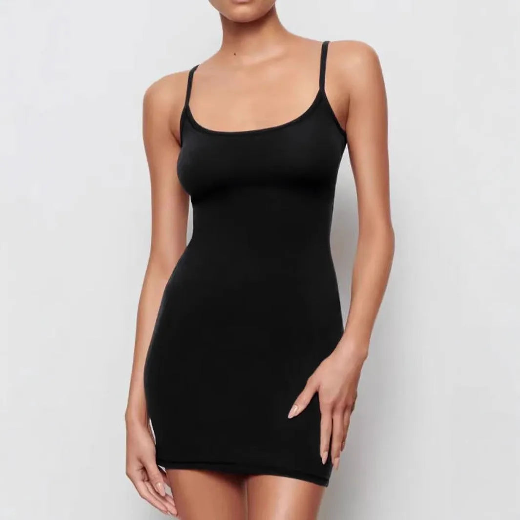 A black sleeveless sling dress with a slim sheath silhouette and short hemline on a hanger.