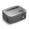 T20 Mini Projector in silver black with LED lens, remote control, and power cord on a table