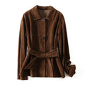 Yellow brown mid-length cashmere coat with a Peter Pan collar and leather stitching on a hanger.