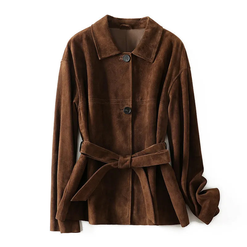 Yellow brown mid-length cashmere coat with a Peter Pan collar and leather stitching on a hanger.