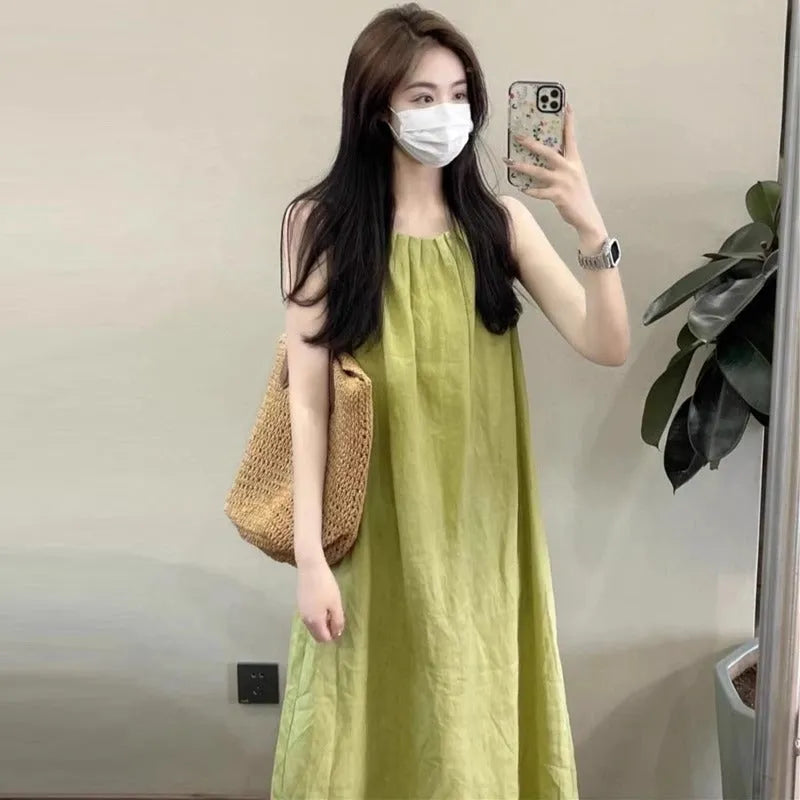 Plus size women's sleeveless asymmetric cotton vest skirt in green with black pants option on model