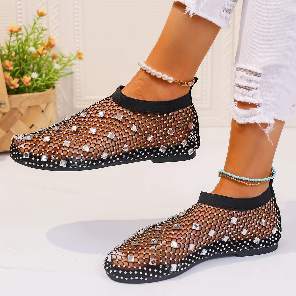 Women's white and colourful mesh flat sandals with rhinestone decoration and a round toe.