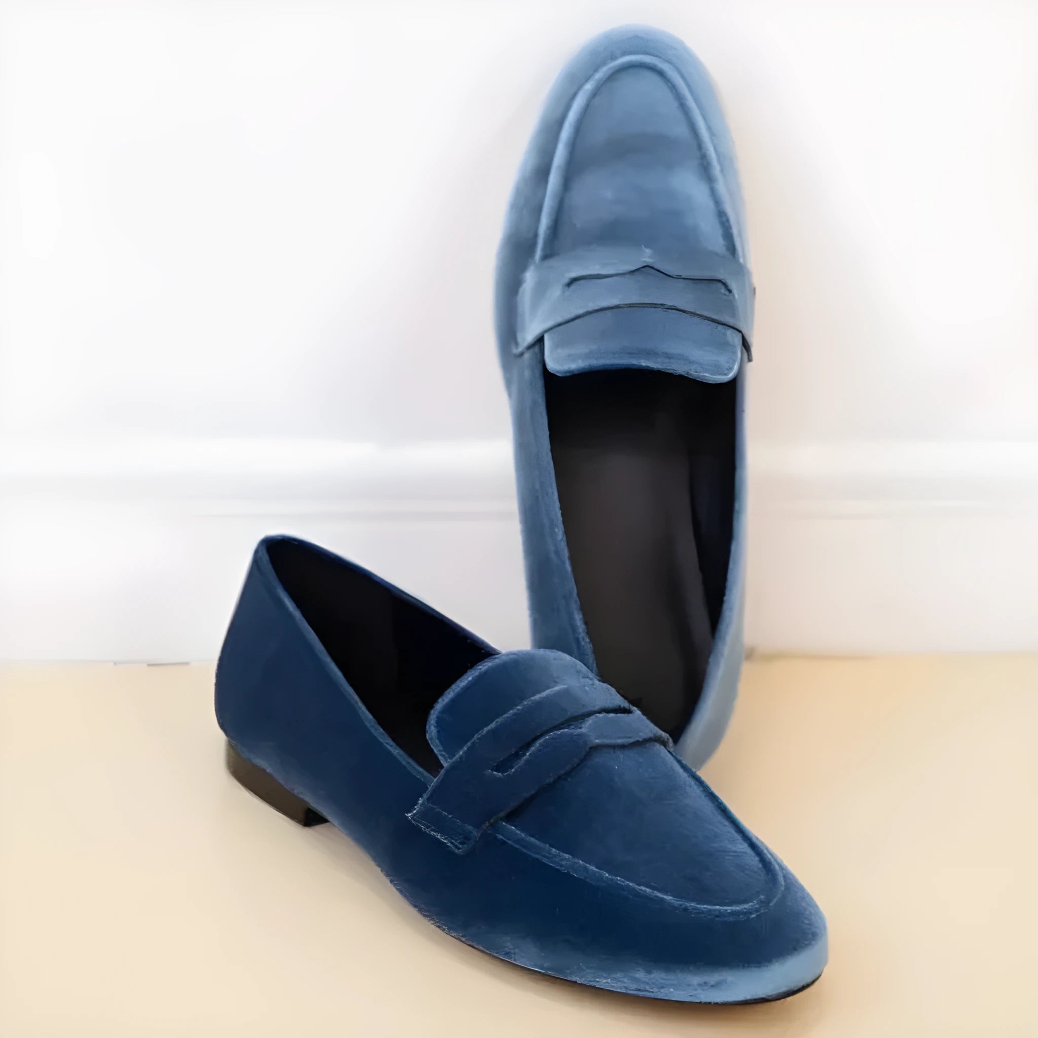 Blue and black sole leisure flat suede loafers for women with round toe on a rubber sole.