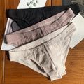 Men's triangle underwear briefs in solid colours showing cotton fabric texture and mid waist design