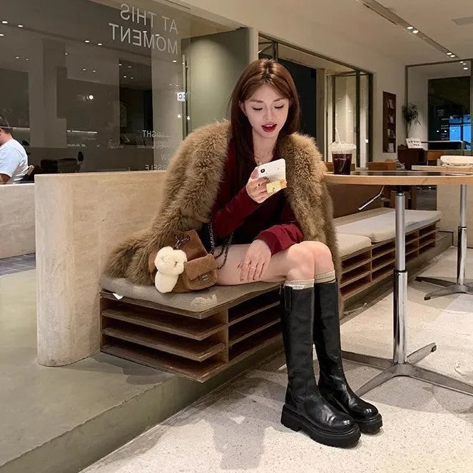 Women's black chunky heel knight boots with round toe and back zipper showing side profile