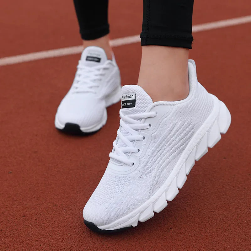 Women's black and white casual running sneakers with cross strap design and MD sole