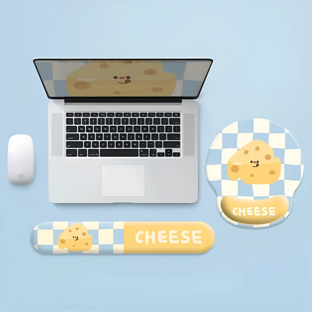 Cartoon cheese wrist rest mouse pad with keyboard holder placed on a wooden desk next to a notebook computer
