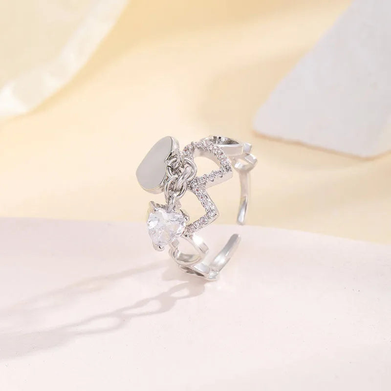 Silver electroplated copper adjustable heart ring for women on white background
