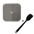 Square orange and grey silicone dog licking mat with textured surface and suction cups on the back.