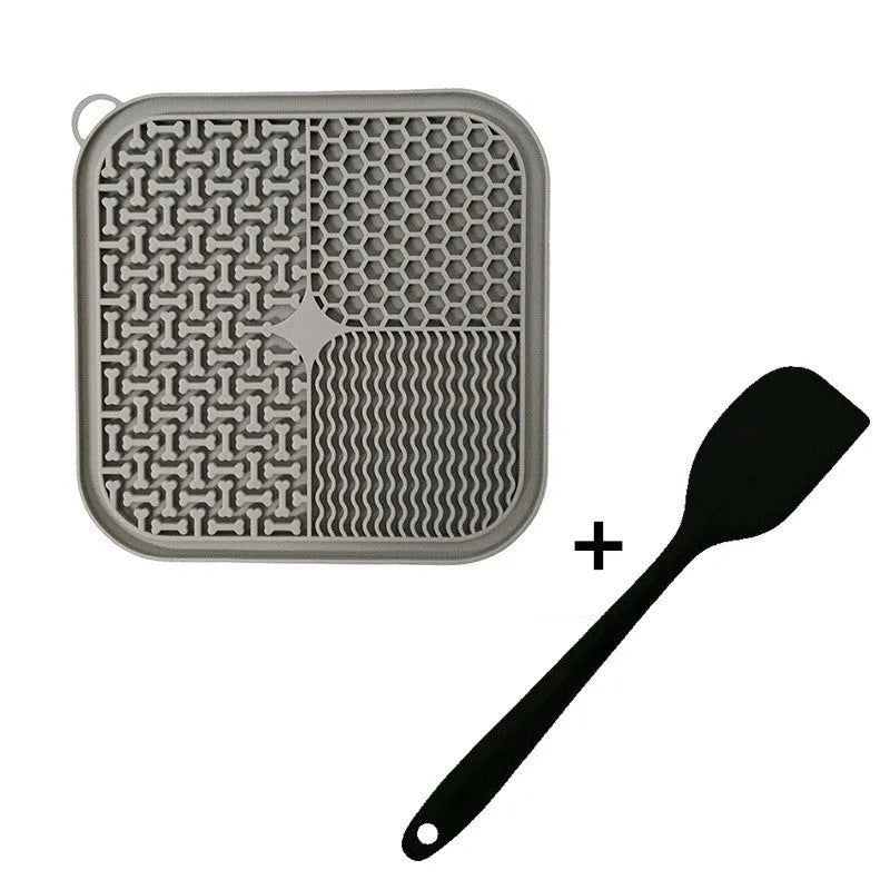 Square orange and grey silicone dog licking mat with textured surface and suction cups on the back.