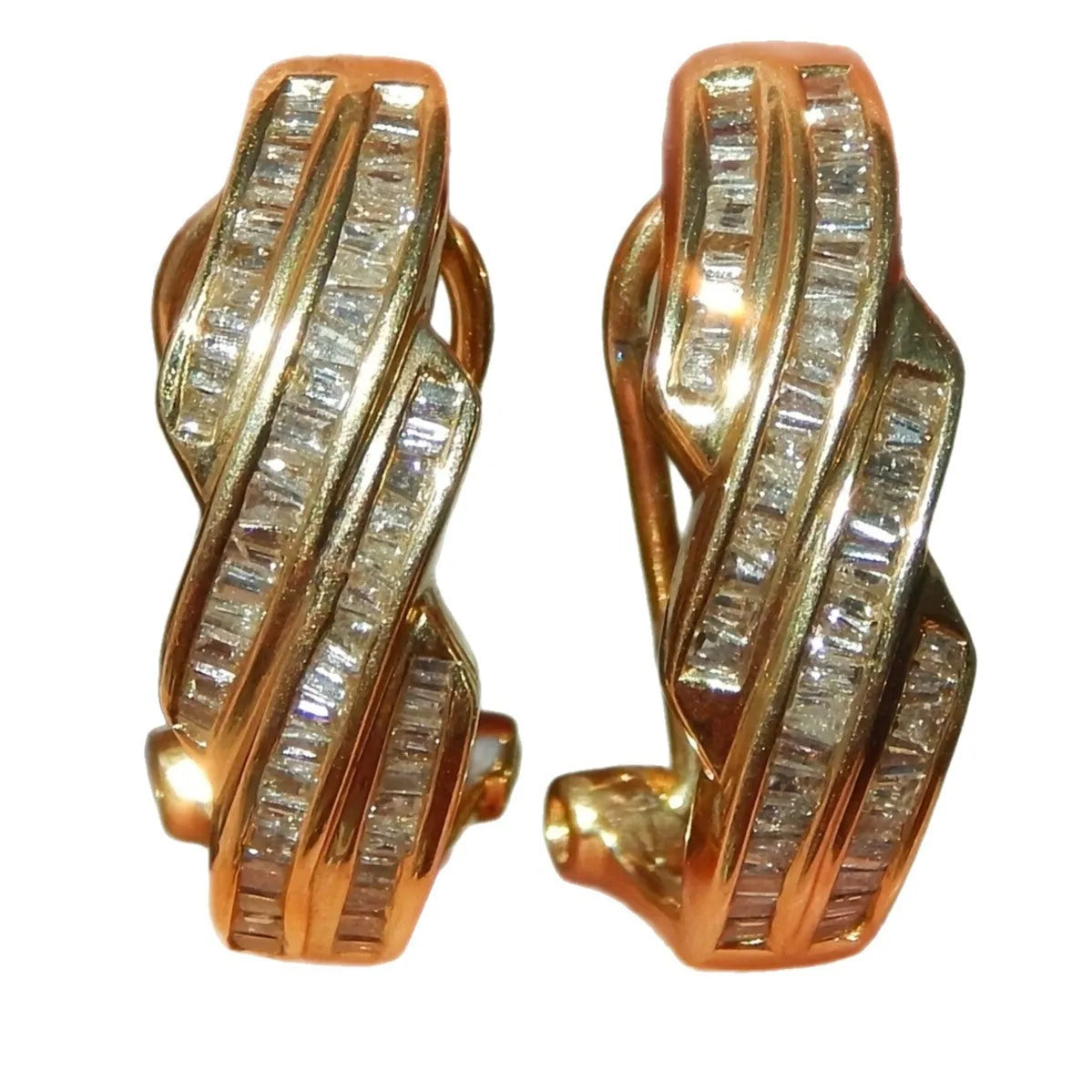 A pair of gold-coloured geometric earrings made from copper with round design elements.